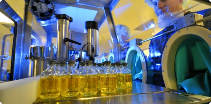 person working in factory for filling vial