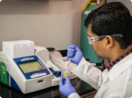 Scientist analyzing a pharmaceutical sample using laboratory equipment