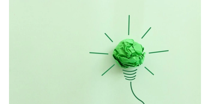Green paper light bulb symbolizing sustainable innovation, eco-friendly ideas, and environmental responsibility