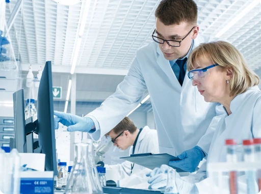 Pharmaceutical researchers analyzing laboratory data during drug development and clinical research process