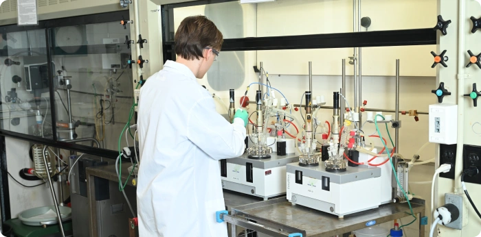 Scientist performing clinical manufacturing of drug substances in a GMP-compliant laboratory