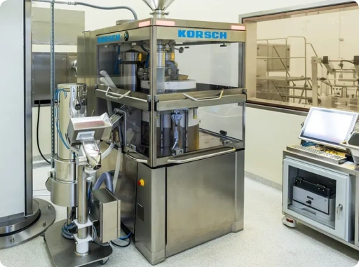 Automated tablet compression machine for pharmaceutical solid dosage manufacturing in GMP facility