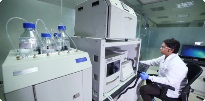 A scientist in a laboratory operating a Waters SFC Prep 15/100 system to purify milligram-to-gram quantities of compounds for drug discovery bioassays