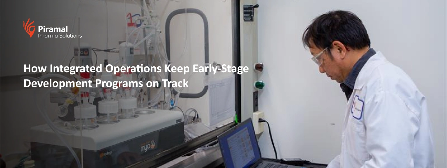 Research scientist monitoring automated bioreactor system during early-stage development and integrated lab operations