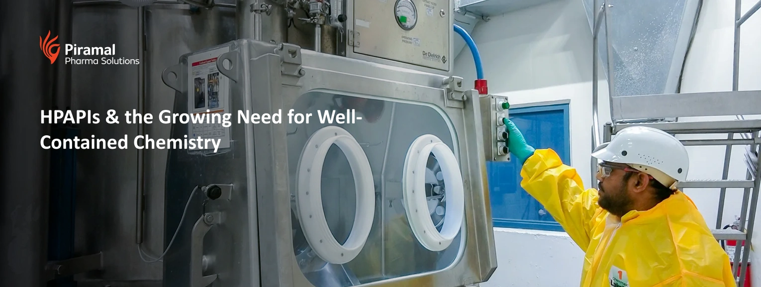 Operator handling high potency API in a contained glovebox system for safe pharmaceutical manufacturing and contamination control