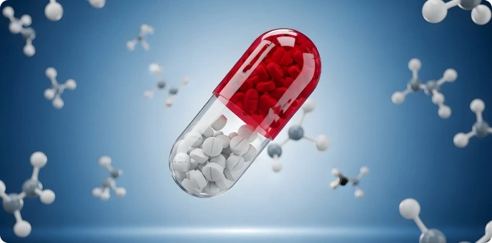 Red and white capsule pill with molecular structures symbolizing pharmaceutical drug development and small molecules