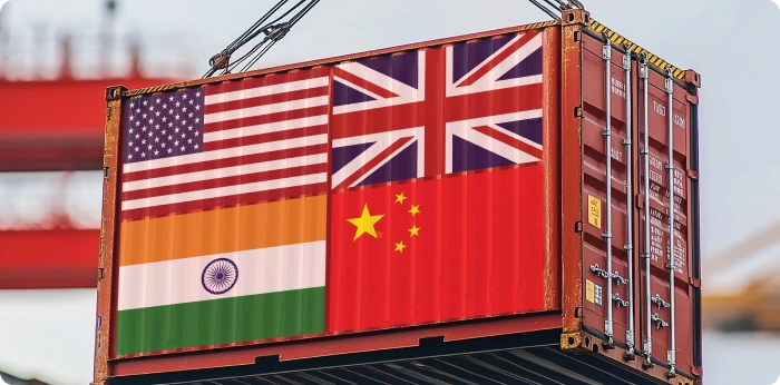 Shipping container with flags of China, India, the US, and the UK representing China Plus One supply chain diversification