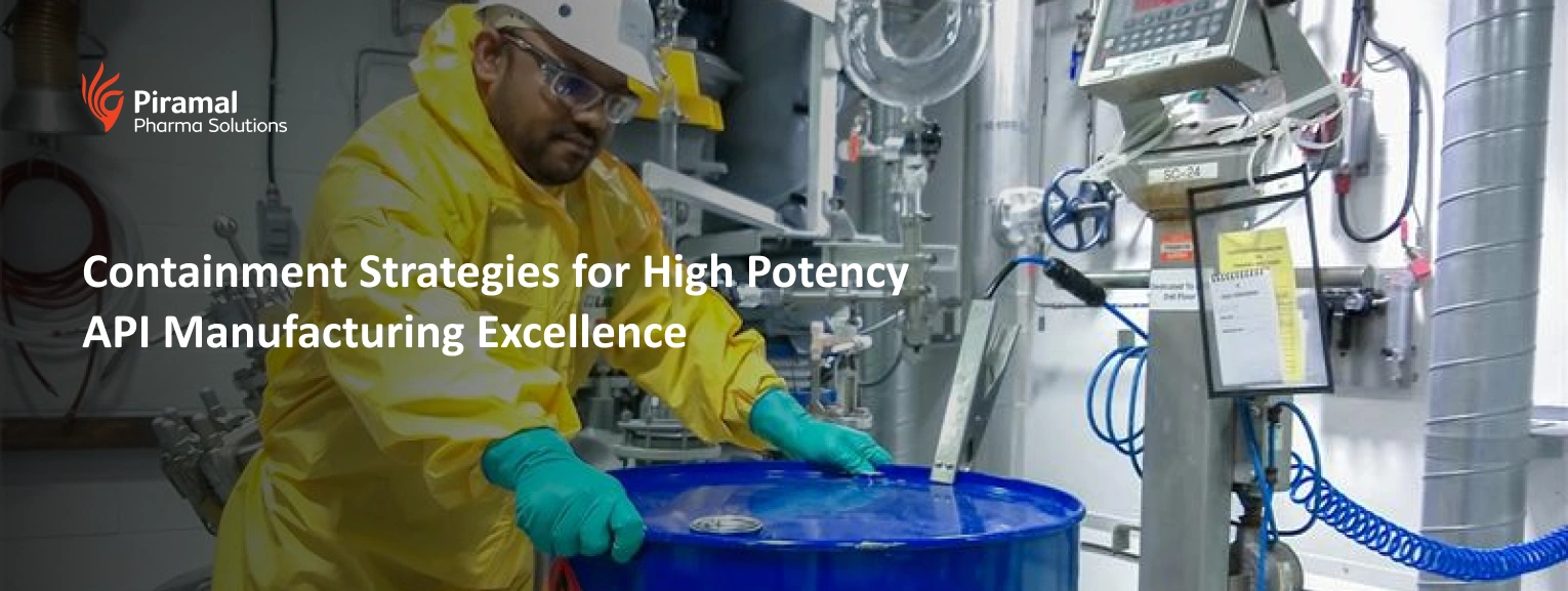 Technician handling containment equipment in a high potency API manufacturing facility