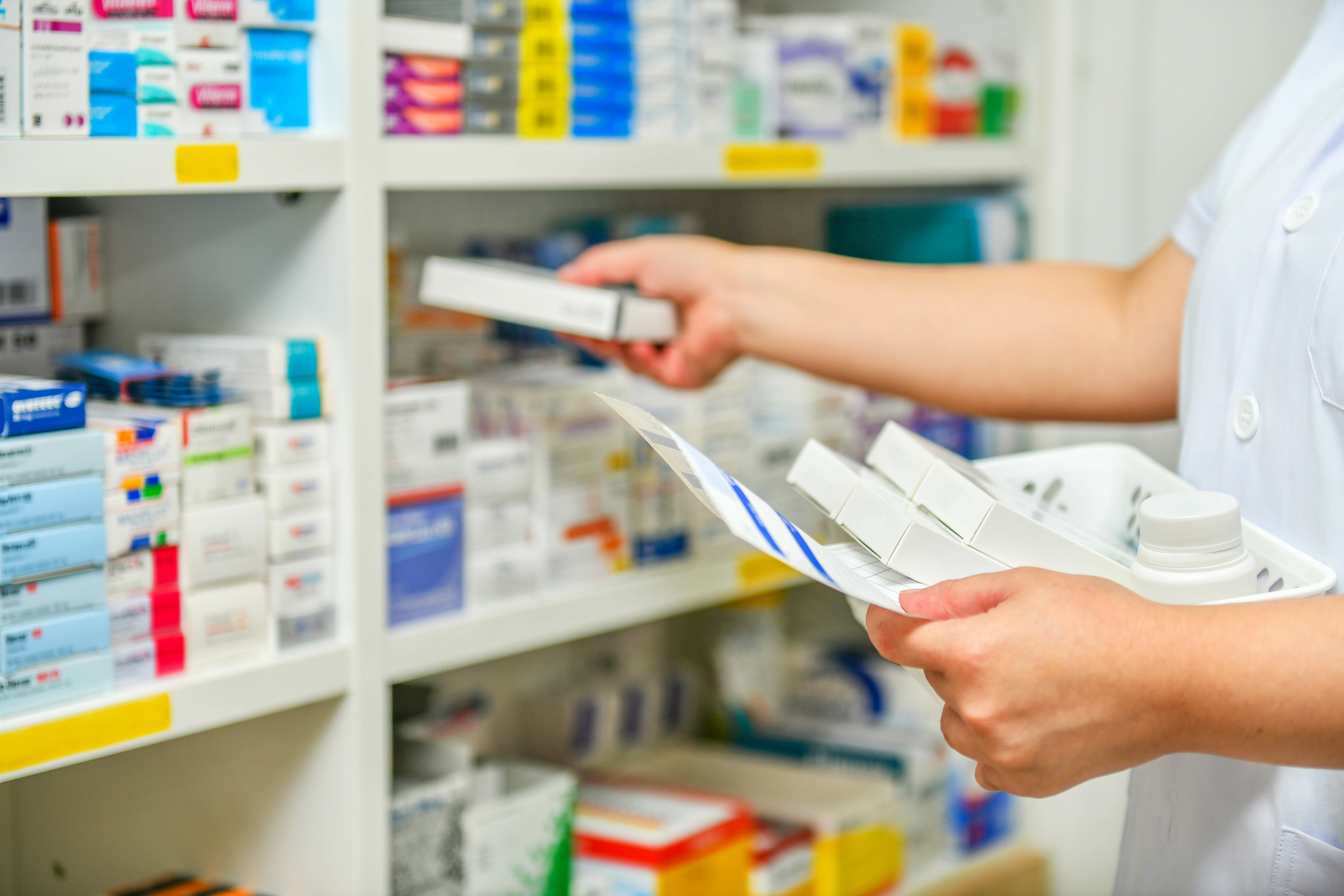 Pharmacist filling prescription in pharmacy store